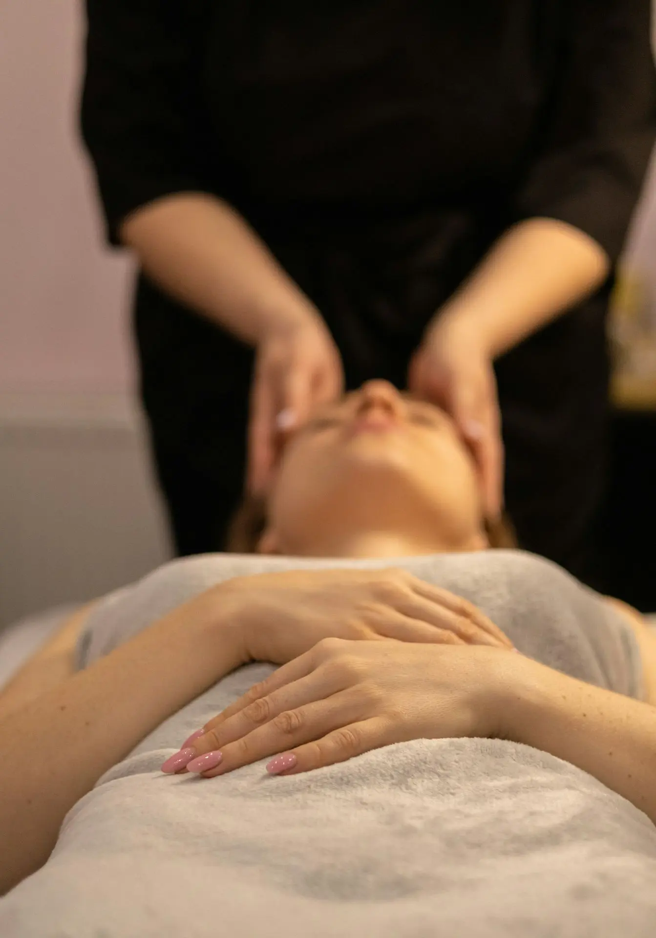 a woman getting a facial massage at a spa